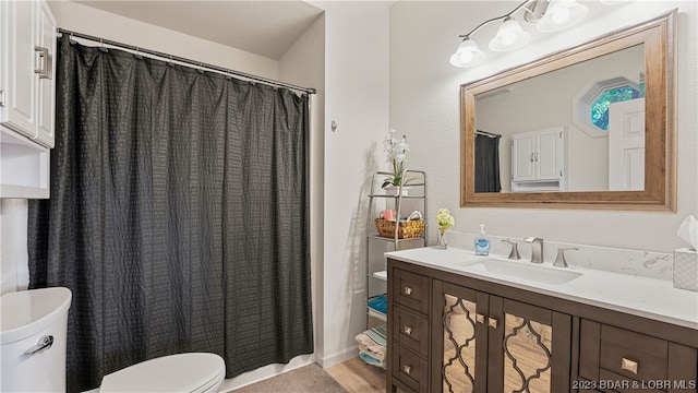 bathroom featuring walk in shower, vanity, hardwood / wood-style floors, and toilet