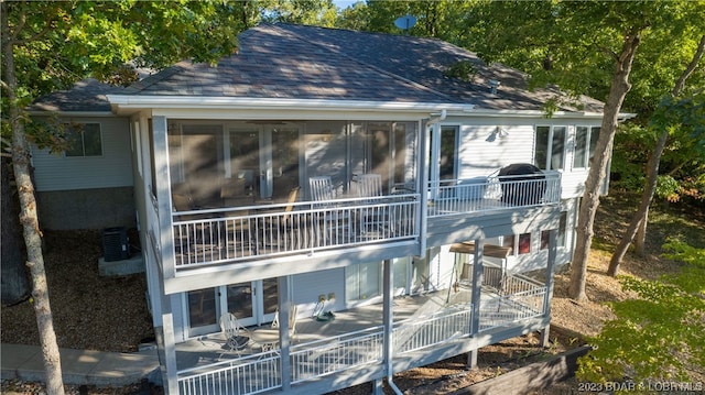 exterior space with a sunroom and cooling unit