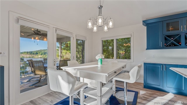 dining room featuring a notable chandelier and light wood-type flooring