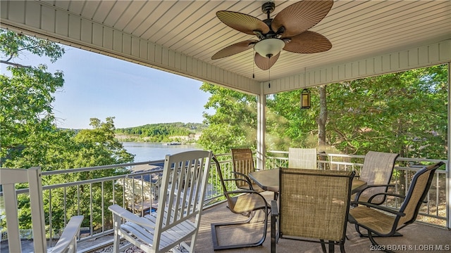 view of patio / terrace with ceiling fan and a water view