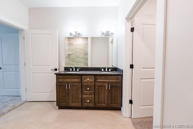 bathroom featuring vanity, a shower, and tile patterned flooring