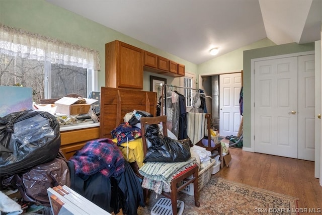 miscellaneous room with lofted ceiling and light hardwood / wood-style flooring