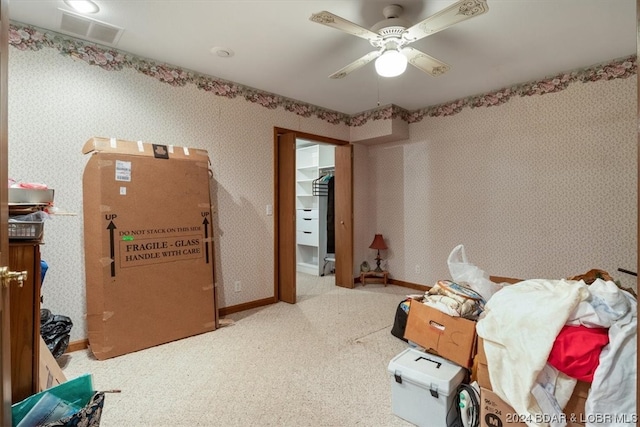 carpeted bedroom featuring a closet and ceiling fan