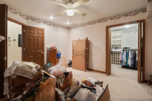 miscellaneous room with ceiling fan and light colored carpet