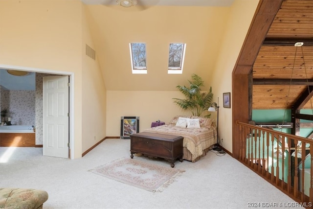 bedroom with a skylight, a high ceiling, and light wood-type flooring