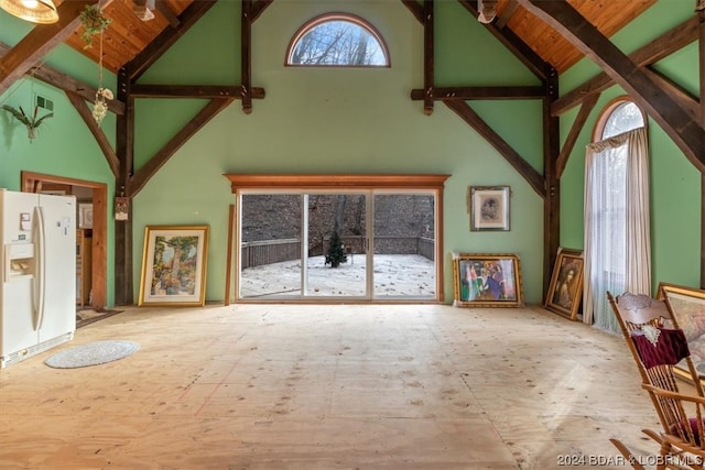 unfurnished living room with high vaulted ceiling, beam ceiling, and wood ceiling