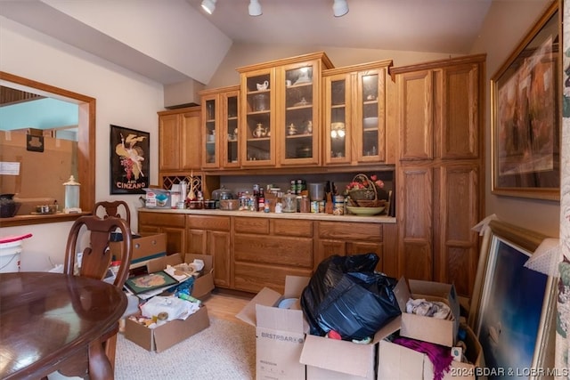 kitchen featuring lofted ceiling and light hardwood / wood-style floors