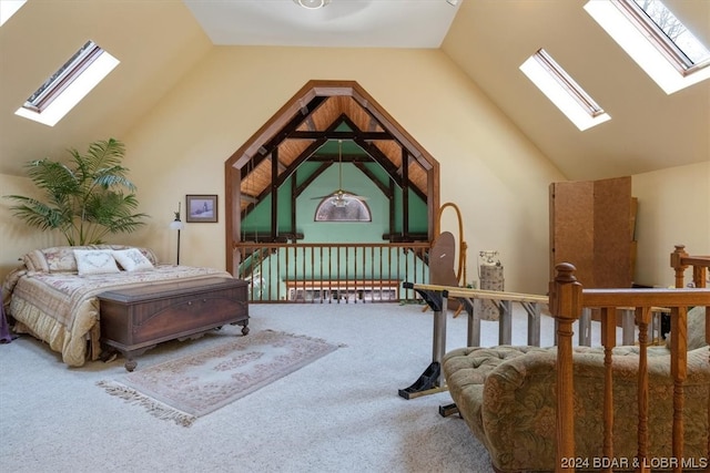 bedroom featuring lofted ceiling with skylight, multiple windows, and carpet