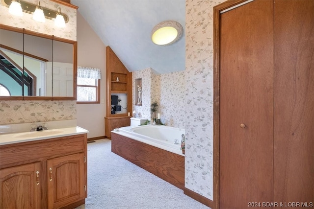 bathroom featuring vaulted ceiling, a bath, and oversized vanity