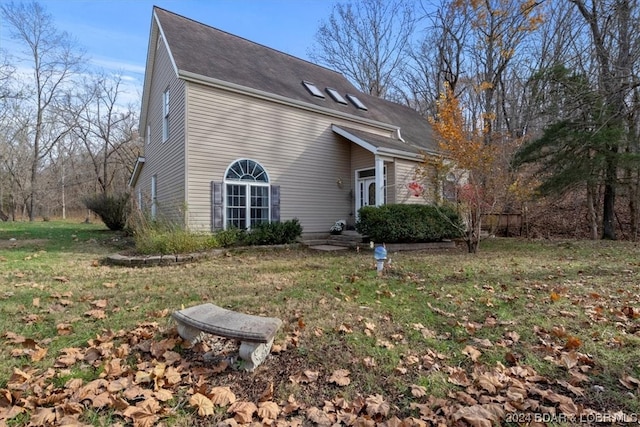 view of side of property with a lawn