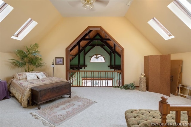 bedroom with a skylight, ceiling fan, light colored carpet, and high vaulted ceiling