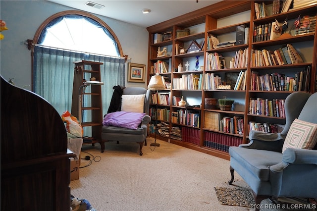 sitting room featuring light colored carpet