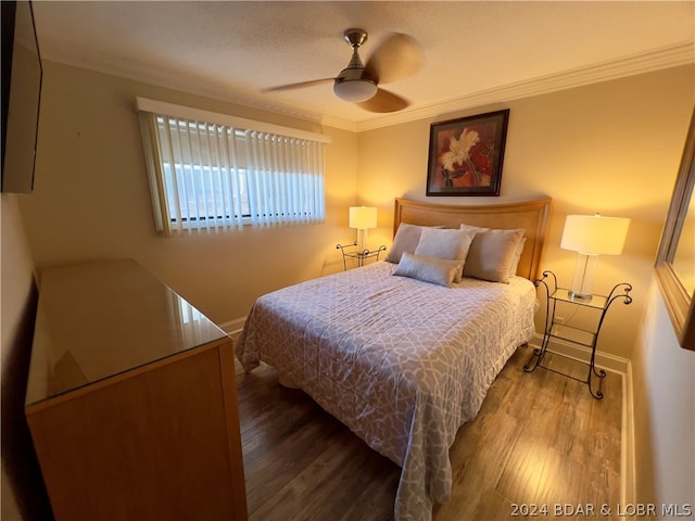 bedroom with hardwood / wood-style floors, ceiling fan, and ornamental molding