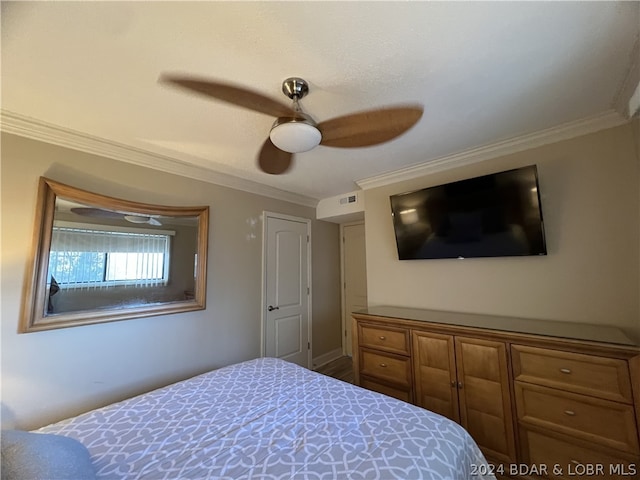 bedroom featuring ceiling fan and ornamental molding