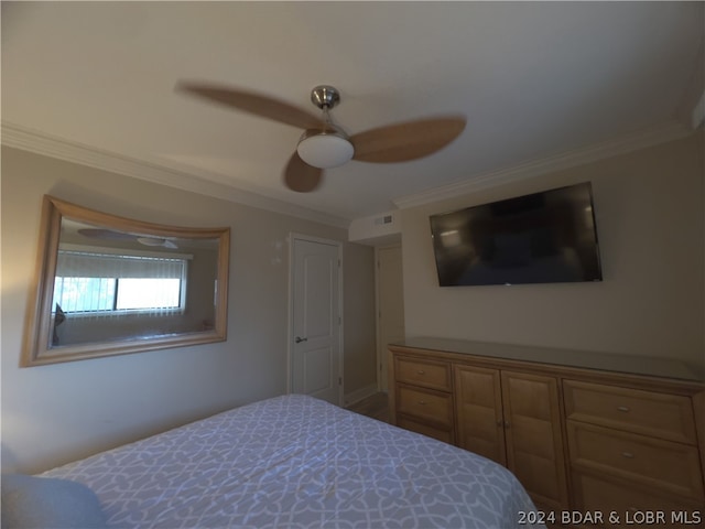 bedroom with ceiling fan and crown molding