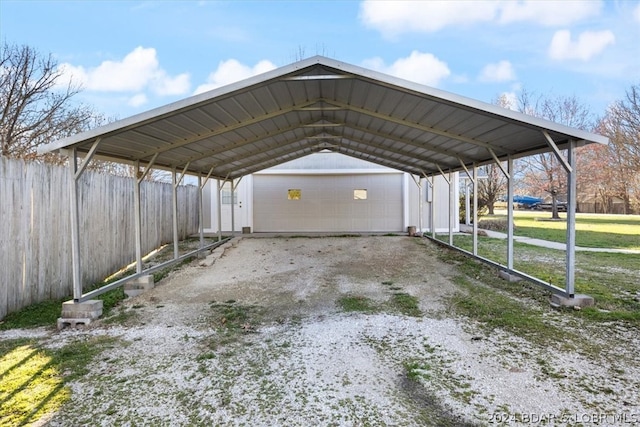 view of parking with a carport, a garage, and a yard