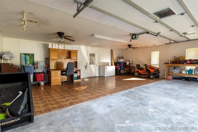 garage with ceiling fan and a garage door opener