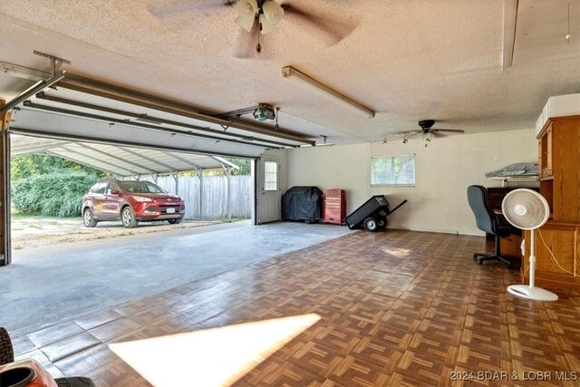 garage with a garage door opener and ceiling fan