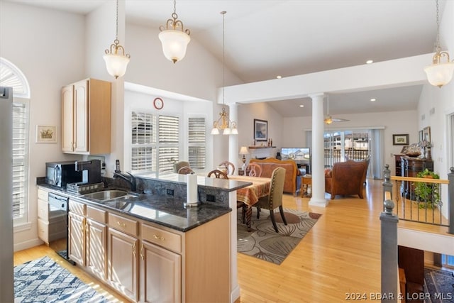 kitchen featuring light brown cabinets, decorative columns, and a wealth of natural light