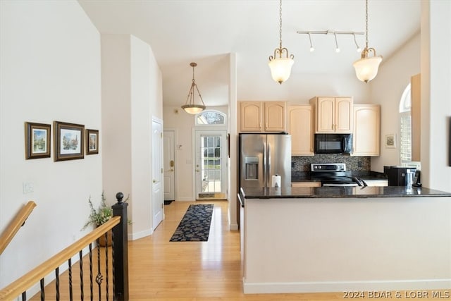 kitchen featuring pendant lighting, tasteful backsplash, stainless steel fridge, range with electric cooktop, and light hardwood / wood-style flooring