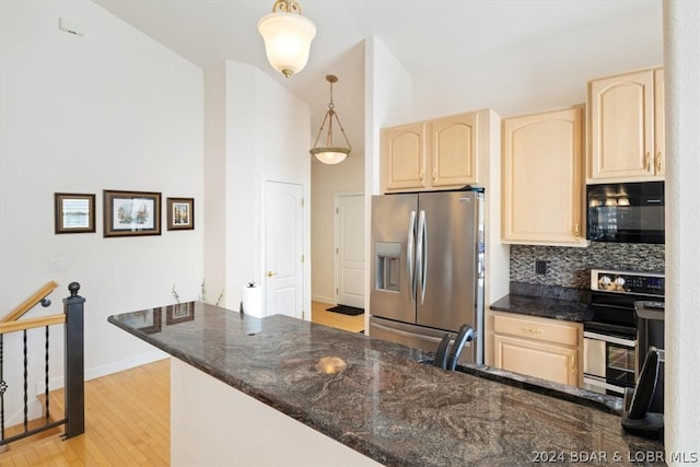 kitchen featuring light hardwood / wood-style floors, electric range, tasteful backsplash, stainless steel fridge, and hanging light fixtures