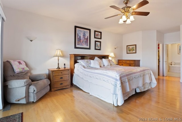 bedroom featuring ensuite bathroom, a closet, ceiling fan, and light wood-type flooring