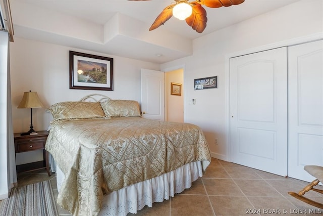 tiled bedroom featuring a closet and ceiling fan