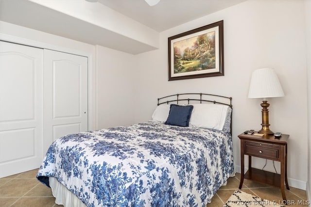 bedroom with light tile floors and a closet