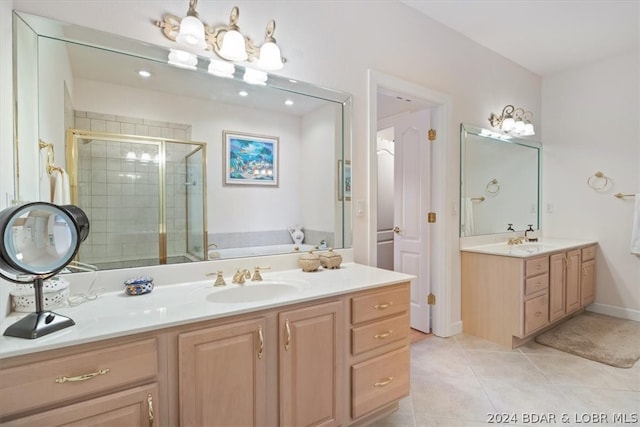 bathroom featuring shower with separate bathtub, double sink vanity, and tile flooring