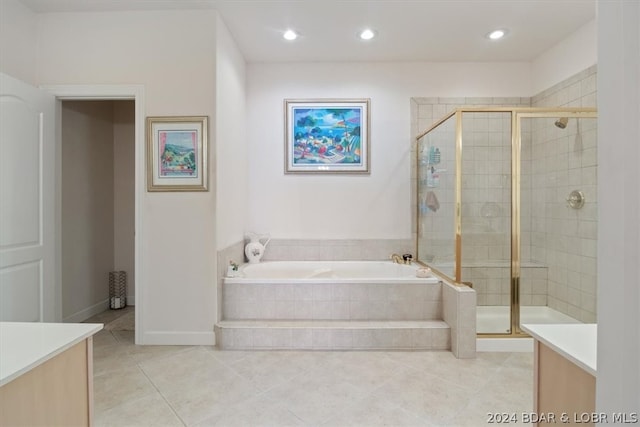 bathroom featuring separate shower and tub, vanity, and tile flooring