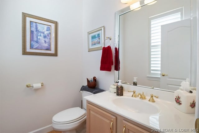 bathroom featuring toilet and vanity