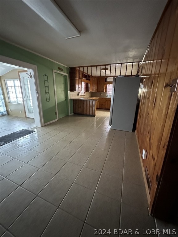 unfurnished living room featuring light tile flooring