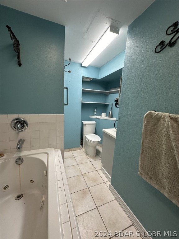 bathroom with tile flooring, toilet, and vanity