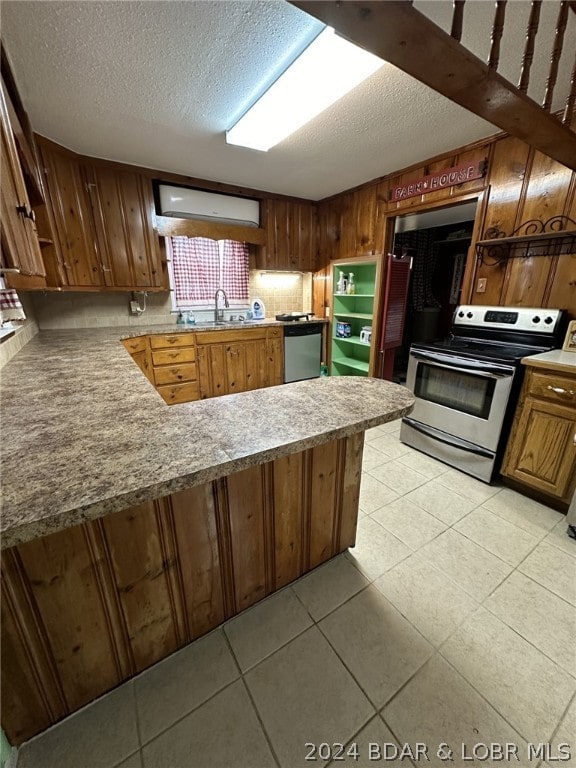 kitchen featuring sink, a textured ceiling, and appliances with stainless steel finishes