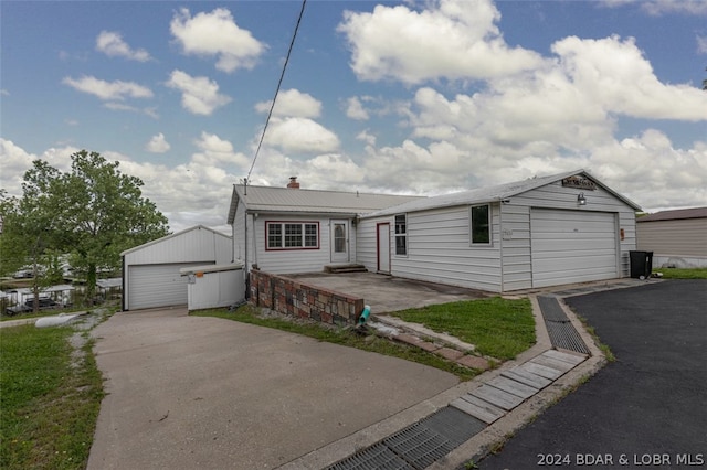 view of front facade with a garage and an outdoor structure