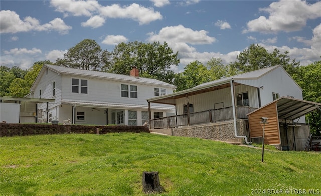 rear view of property with a yard