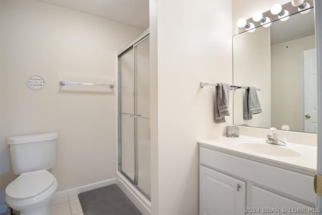 bathroom with walk in shower, toilet, tile floors, and large vanity