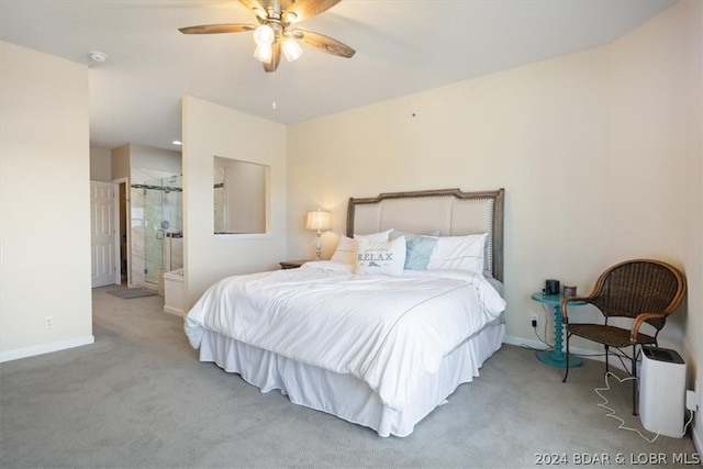 bedroom with ceiling fan, ensuite bath, and light carpet