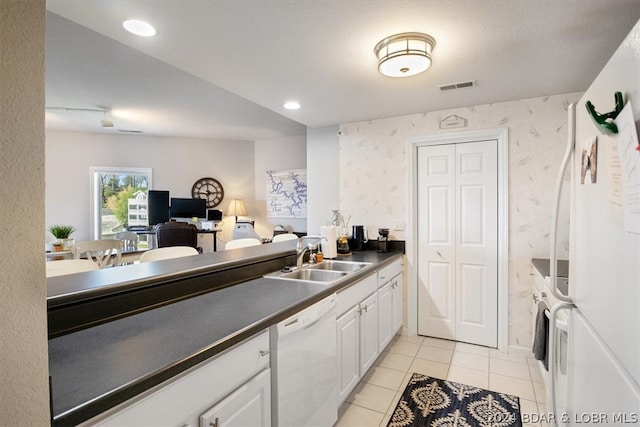 kitchen with white cabinetry, white appliances, sink, and light tile floors