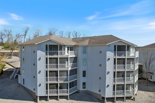 back of property featuring a balcony