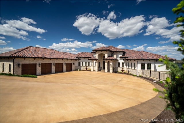 mediterranean / spanish-style home featuring a garage