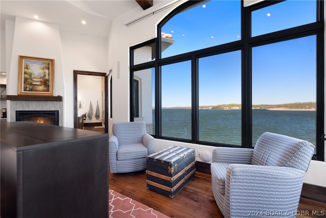 living room with a water view and dark wood-type flooring