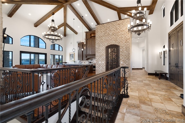 hall with high vaulted ceiling, beam ceiling, a chandelier, and light tile floors