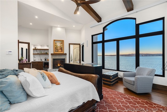 bedroom featuring high vaulted ceiling, a water view, beamed ceiling, a fireplace, and dark hardwood / wood-style flooring