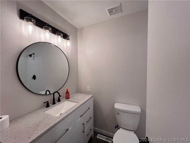 bathroom featuring oversized vanity and toilet