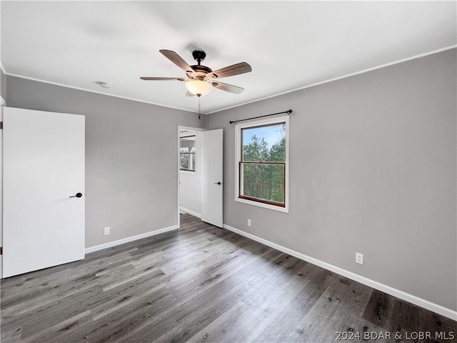 empty room with crown molding, ceiling fan, and hardwood / wood-style floors