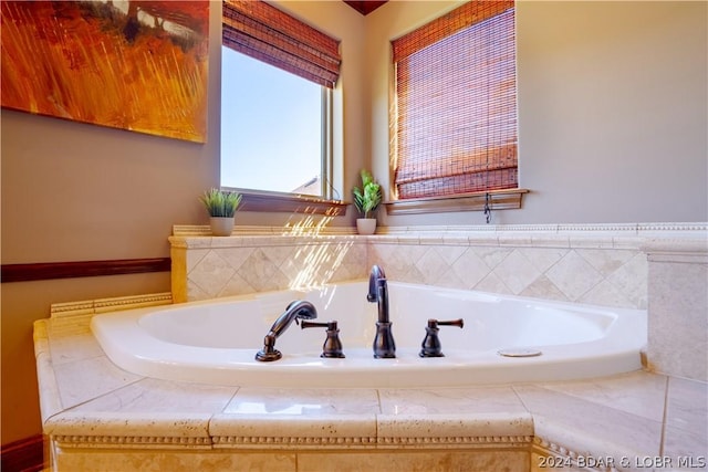 bathroom featuring a relaxing tiled tub