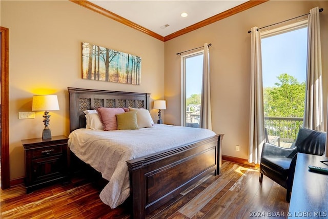 bedroom featuring crown molding, dark hardwood / wood-style flooring, and access to exterior