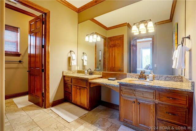 bathroom with ornamental molding and vanity