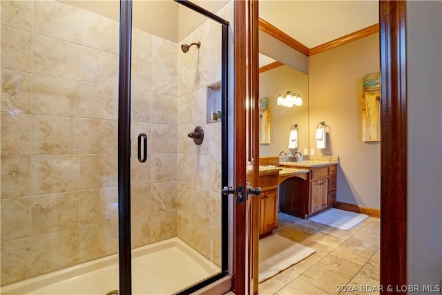 bathroom featuring crown molding, vanity, and a shower with door